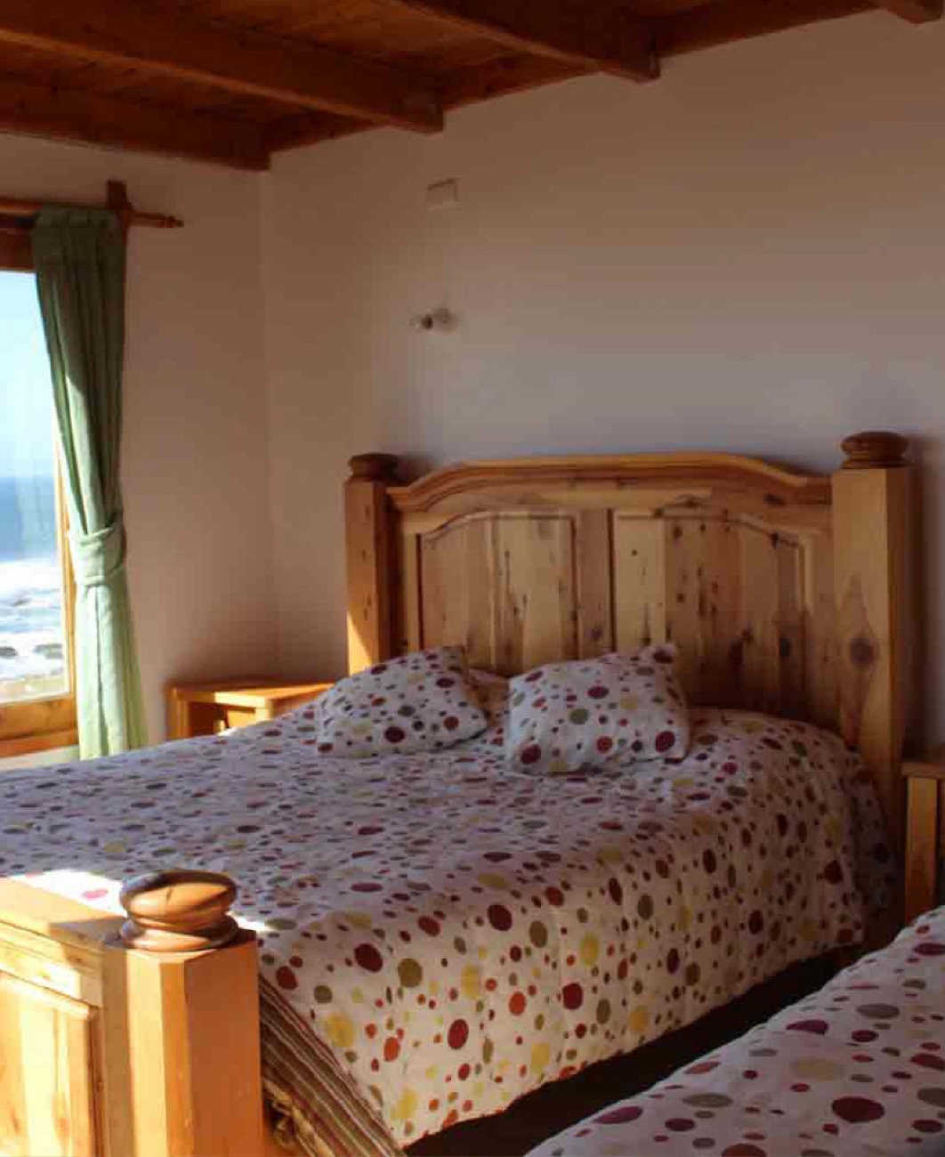 Cabaña Gilberto con cama y techo de madera, luz de mar